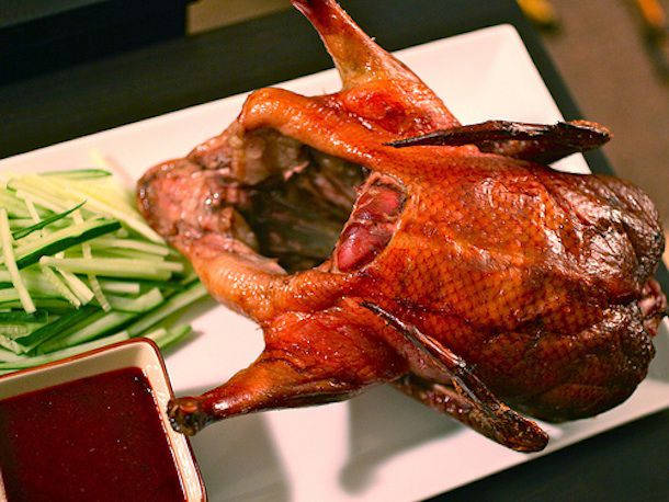 Whole roasted Peking Duck with a golden-brown, crispy exterior. 